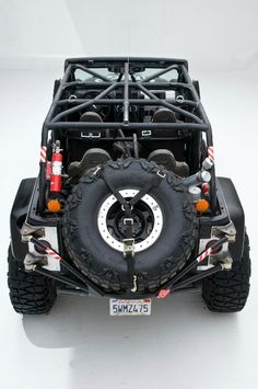 the front end of a four - doored off - road vehicle with large tires