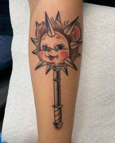 a tattoo on the leg of a person with a key in its hand and an evil face