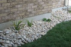 there is a small rock garden in front of the house