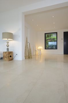 an empty living room with white walls and flooring