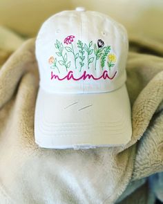 Welcome to my shop! This mama floral hat is a one size fits most and is embroidered with high quality thread! It is customizable. If you would like to change the thread colors please leave me a note at check out! Its also a ponytail style hat so you can wear it with your hair up or down! If you have any questions please send me a message! Thank you for stopping by! Pink Embroidered Spring Hat, Adjustable Floral Embroidered Baseball Cap, Spring Embroidered Pink Baseball Cap, Floral Embroidered Brimmed Hat, One Size, Pink Embroidered Baseball Cap, Mama Hat, Mom Hat, Hair Up Or Down, Mom Hats