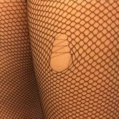 the back of a woman's legs with fishnets on them and a circle in the middle