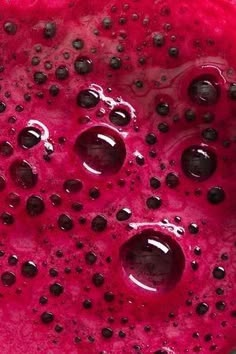 a close up view of watermelon juice with black dots on the top and bottom