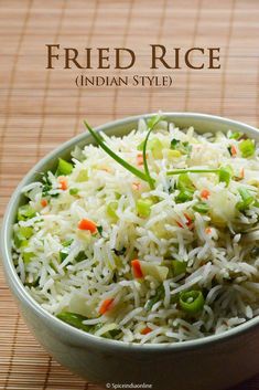 a bowl filled with rice and vegetables on top of a table