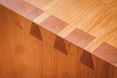 a close up view of a wooden table with different shapes and sizes on the surface