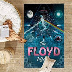 the floyd poster is next to a table with pillows and other items on top of it