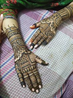 two hands with henna designs on them