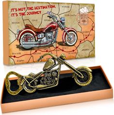 a motorcycle is on display in a wooden box with a map behind it that says it's not the destination, it's true - journey