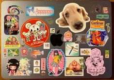 a laptop covered in stickers with a dog's face