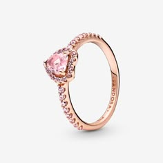 Add a sophisticated touch to your look with the Sparkling Elevated Heart Ring. The ring draws inspiration from the classic Pandora Timeless collection. Hand-finished in 14k rose gold unique metal blend, this piece features a pink heart-shaped central, elevated stone. Clear cubic zirconia create the halo and decorate half of the ring band, with the Pandora logo inside the shank. Stack this ring with hand-finished styles in sterling silver for a statement mixed metal look. Pandora Sparkling Elevat Elevated Heart Ring, Jewelry Chain Types, Pandora Rings Heart, Pink Heart Rings, Jewelry Making Rings, Pandora Rose Gold, Charms Pandora, Pandora Rings, Pink Ring