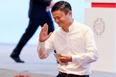 a man in white shirt and black pants clapping