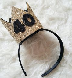 a gold and black crown with the number forty nine on it's headband