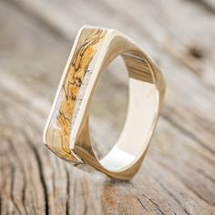 a wooden ring sitting on top of a wooden table