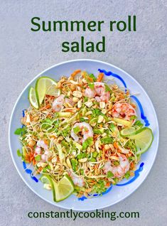 a white plate topped with shrimp and veggies next to lime wedged rice