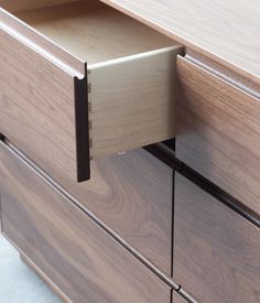 a close up of a drawer on a wooden dresser