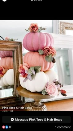 pink roses and hair bows are stacked on top of each other in front of a mirror