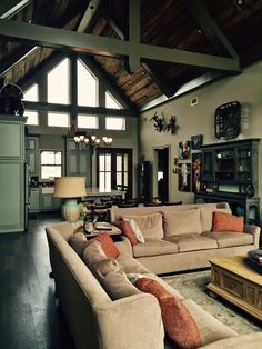 a large open concept living room with wood floors and high ceilings is featured on instagram