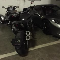 two motorcycles parked next to each other in a parking lot with a sports car behind them