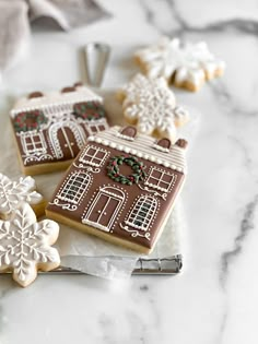 three decorated cookies sitting on top of a counter