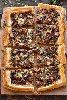 an overhead view of a pizza on a cutting board with mushrooms, cheese and herbs