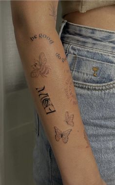 a woman's arm with butterflies on it and the word love written in cursive writing