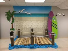 a room with a surfboard on the wall and a rope fence in front of it