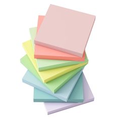 five different colors of paper stacked on top of each other with one being pink, green, blue, and yellow