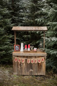 an outdoor hot cocoa stand in the woods