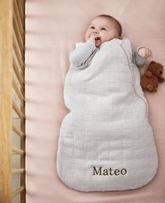 a baby sleeping in a crib with the name mateo on it's blanket