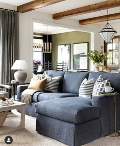 a living room filled with lots of furniture and decor on top of carpeted flooring