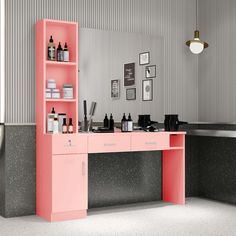 a pink desk with lots of bottles on it in a room that has gray and white walls