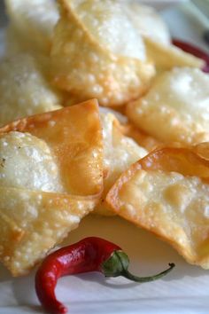 some food on a plate with a red pepper