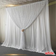 a white curtain is hanging from the ceiling