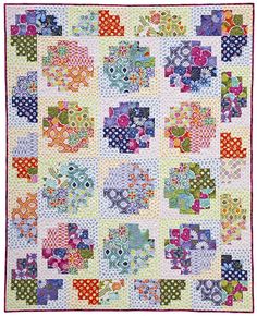 a colorful quilt with many different designs on it