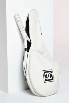 a white guitar case with a measuring tape attached to it