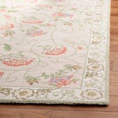 a white rug with floral designs on it