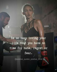 a man and woman standing next to each other with a boxing glove on their hand