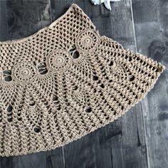 a crocheted purse sitting on top of a wooden floor