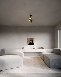 a living room filled with furniture and a painting on the wall