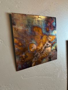 an abstract painting hangs on the wall