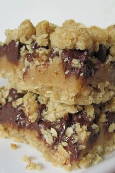 two pieces of chocolate chip cookie bars stacked on top of each other with crumbs