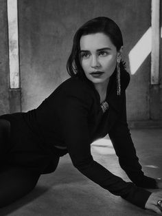 a black and white photo of a woman laying on the ground