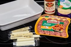 ingredients to make sausage casserole laid out on a black counter with white dishes