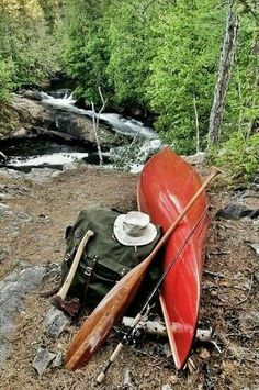 two canoes are sitting on the ground next to a river