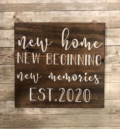 a wooden sign that says new home, new beginning, new memories est 2020