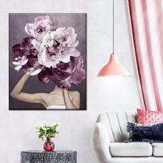 a woman with flowers on her head in a white living room, next to a couch