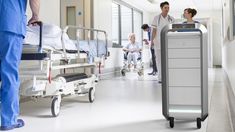 doctors and nurses are in the hallway of a hospital with medical equipment on the floor