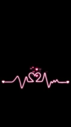 the heartbeat sign is lit up in the dark with pink lights and hearts on it