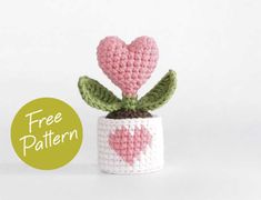 a small crocheted potted plant with a pink heart on it's top