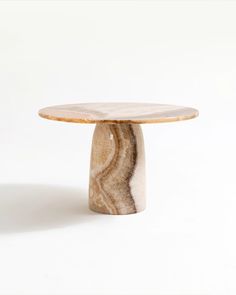 a marble table sitting on top of a white floor